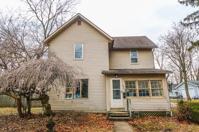 back of property featuring entry steps and fence