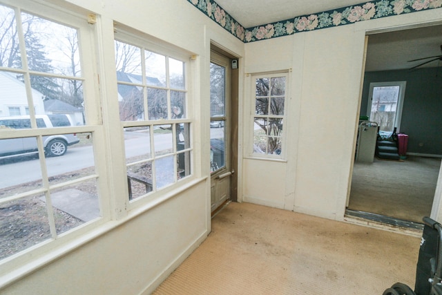 sunroom featuring a ceiling fan