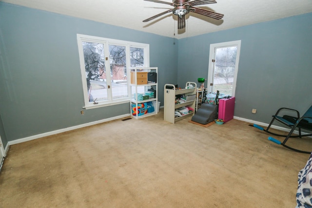 rec room with a ceiling fan, visible vents, baseboards, and carpet flooring