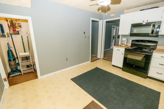 kitchen featuring black appliances, baseboards, white cabinetry, and light countertops