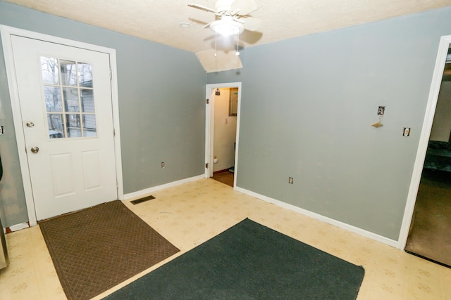 interior space with visible vents, stairway, ceiling fan, a textured ceiling, and baseboards