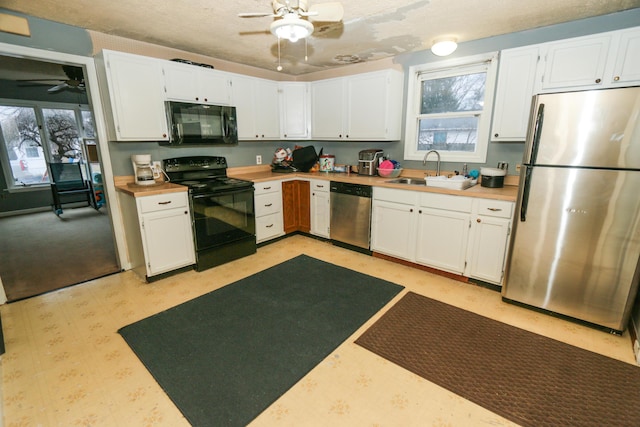 kitchen featuring white cabinetry, a sink, black appliances, and ceiling fan