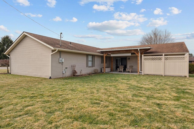 back of house featuring a patio and a lawn