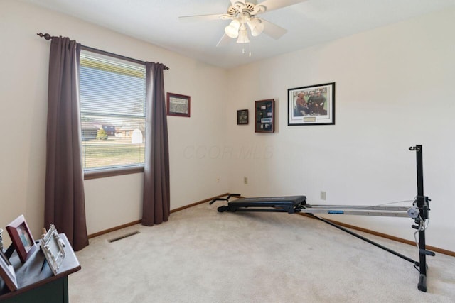 workout area with light carpet, ceiling fan, visible vents, and baseboards