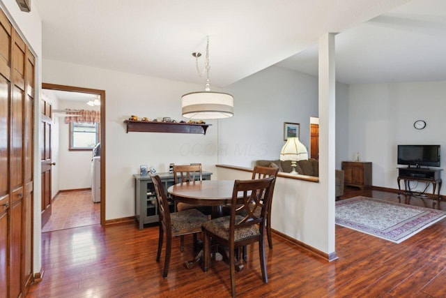 dining space featuring baseboards and hardwood / wood-style floors