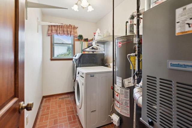 washroom with brick floor, heating unit, water heater, laundry area, and independent washer and dryer