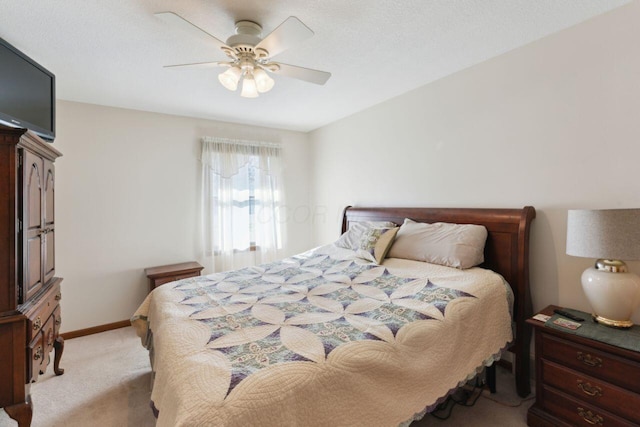 bedroom with light carpet, ceiling fan, and baseboards