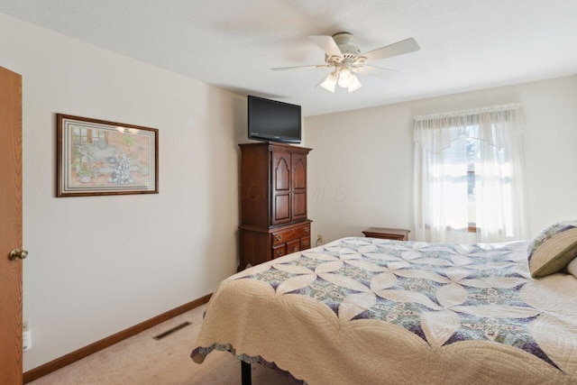 bedroom featuring a ceiling fan, baseboards, visible vents, and carpet flooring