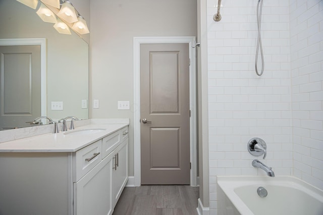 full bathroom featuring vanity, shower / tub combination, and wood finished floors