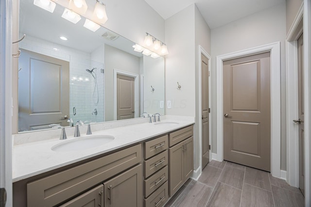 full bath with a stall shower, visible vents, a sink, and double vanity