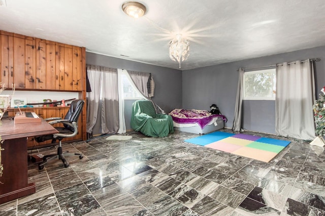 office space featuring marble finish floor and a notable chandelier