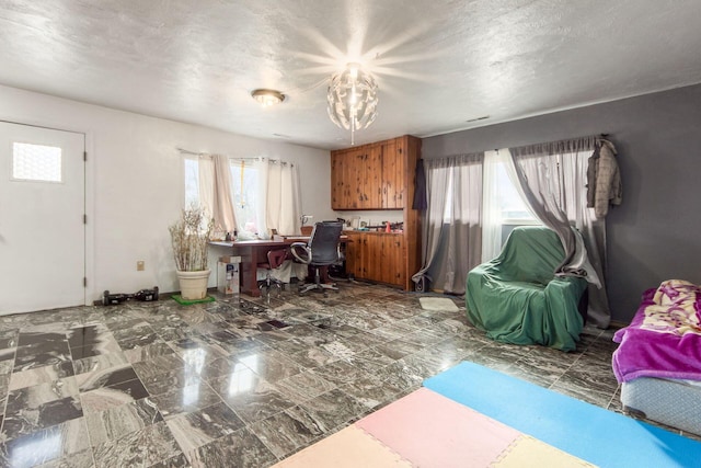 office with marble finish floor and a textured ceiling