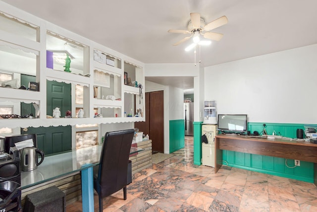 office area with a wainscoted wall and a ceiling fan