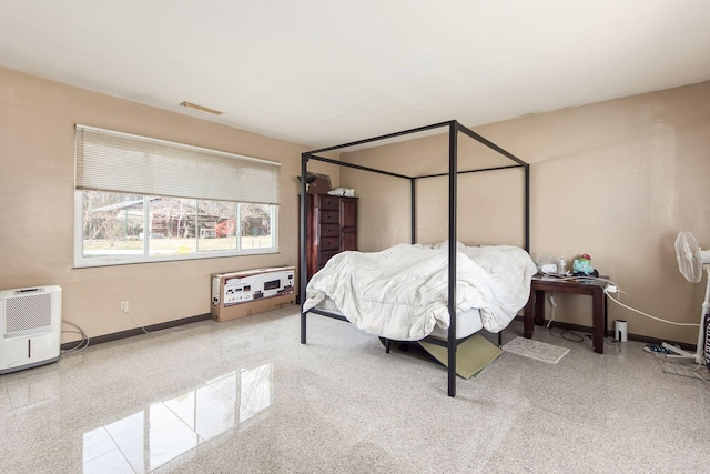 bedroom featuring visible vents, baseboards, and speckled floor