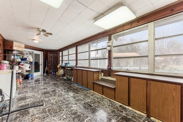 interior space with ceiling fan