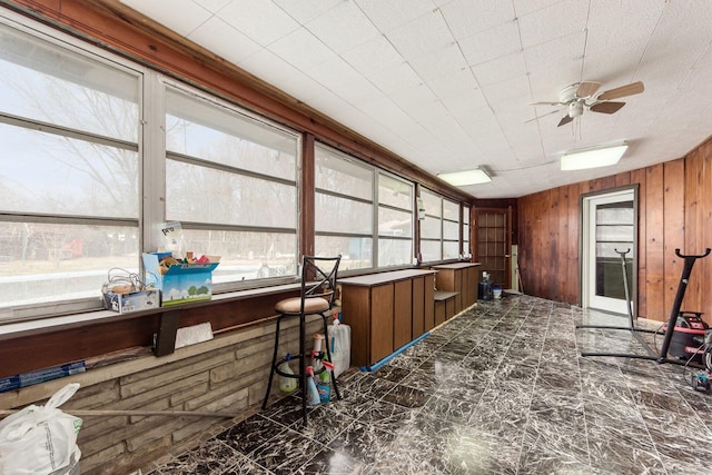 sunroom / solarium featuring ceiling fan