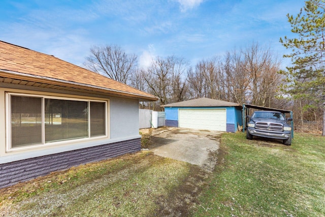 view of home's exterior featuring an outbuilding, roof with shingles, a detached garage, and a lawn