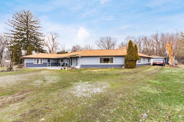 single story home with a chimney and a front lawn