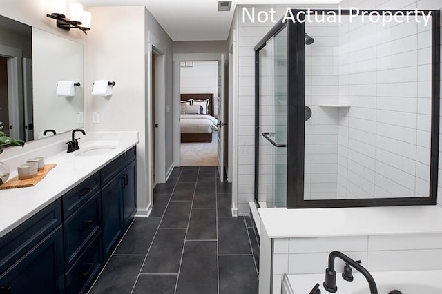 ensuite bathroom featuring tile patterned flooring, visible vents, a shower stall, vanity, and ensuite bath