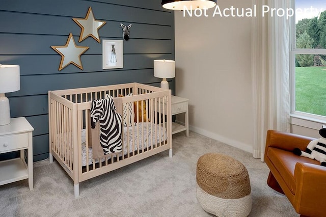 carpeted bedroom featuring a crib