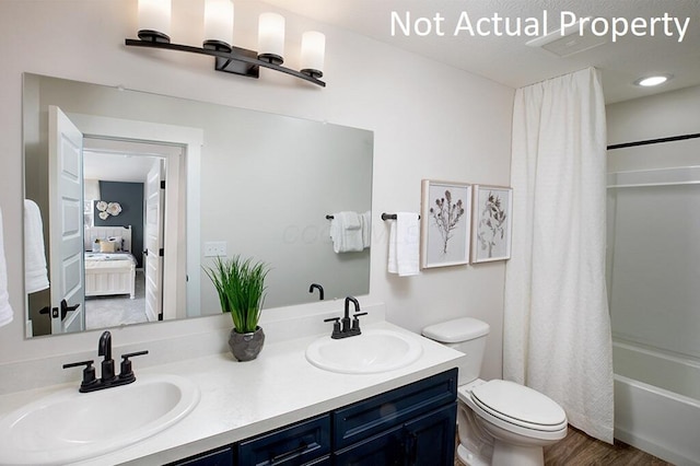 ensuite bathroom with a sink, toilet, double vanity, and shower / bath combination with curtain