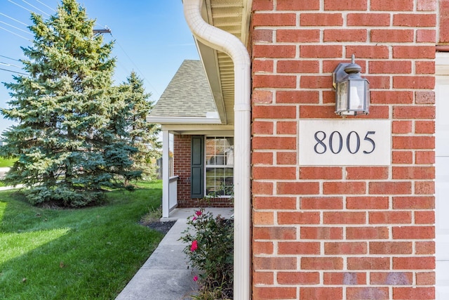 property entrance with brick siding and roof with shingles