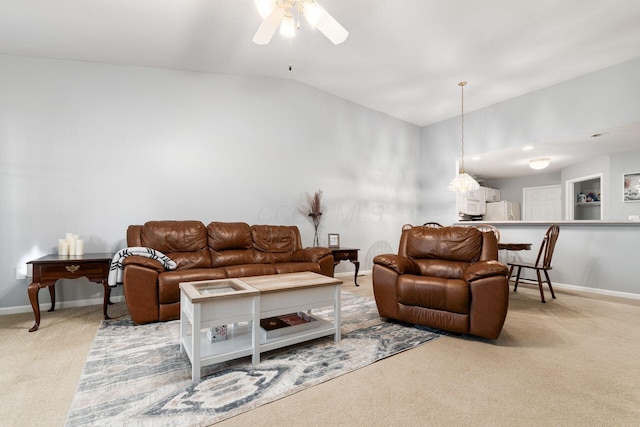 carpeted living area with a ceiling fan, lofted ceiling, and baseboards