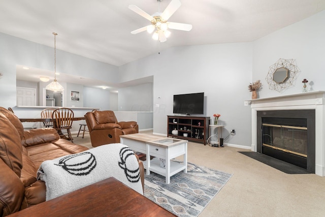 carpeted living room featuring a fireplace with flush hearth, vaulted ceiling, baseboards, and ceiling fan