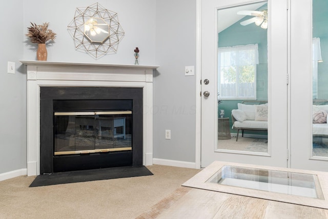 room details with carpet floors, a fireplace with flush hearth, and baseboards