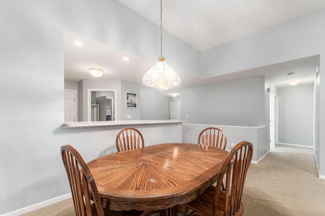 carpeted dining space with baseboards, vaulted ceiling, and recessed lighting