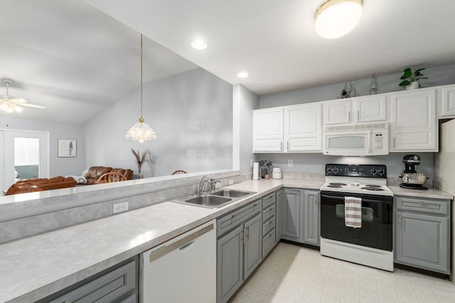 kitchen featuring white appliances, light countertops, and gray cabinetry