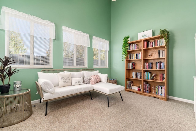 sitting room featuring a wealth of natural light, carpet flooring, and baseboards