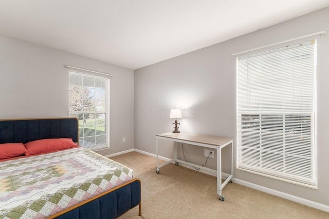 carpeted bedroom featuring baseboards