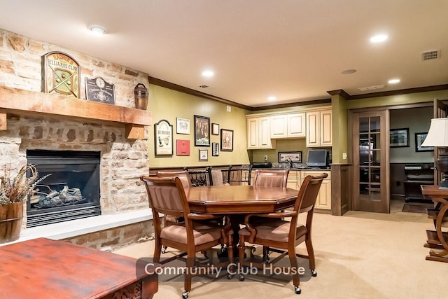 dining area with visible vents, recessed lighting, a fireplace, ornamental molding, and light carpet