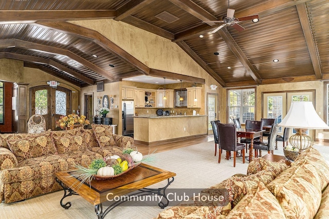 living area with wood ceiling, french doors, beamed ceiling, and a wealth of natural light