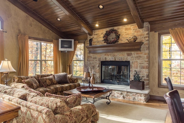 living area with a wealth of natural light, lofted ceiling with beams, and wood finished floors