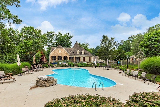 pool featuring a patio and fence