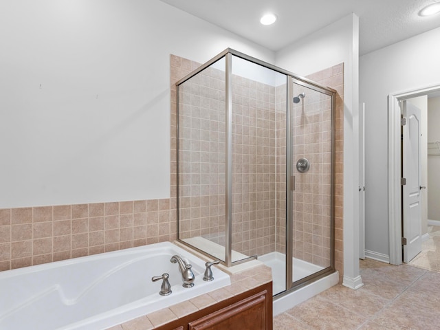 full bathroom with a shower stall, a bath, recessed lighting, and tile patterned floors