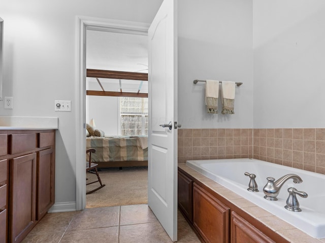 ensuite bathroom with a bath, connected bathroom, and tile patterned floors