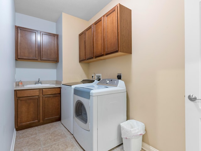 laundry room with a sink, cabinet space, independent washer and dryer, and light tile patterned floors