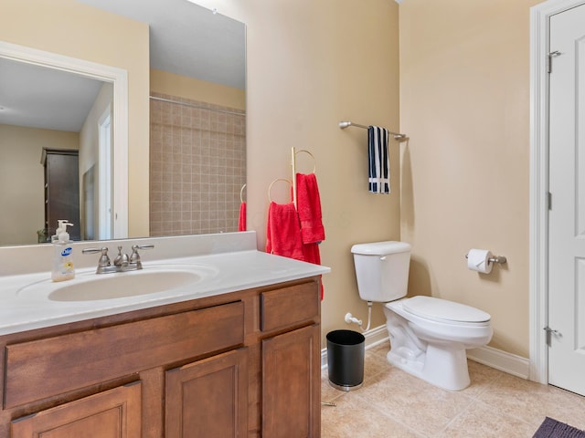 bathroom with vanity, tile patterned floors, toilet, and baseboards