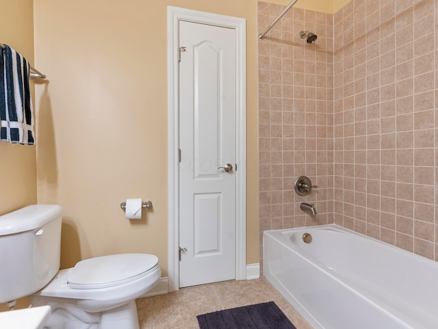 full bath with tile patterned flooring, toilet, baseboards, and washtub / shower combination