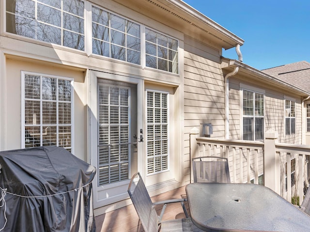 deck featuring a grill and outdoor dining area