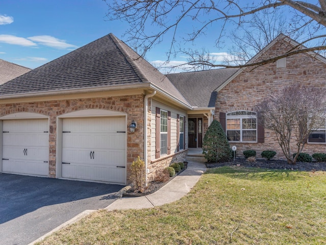 view of side of property featuring a shingled roof, aphalt driveway, a lawn, stone siding, and an attached garage