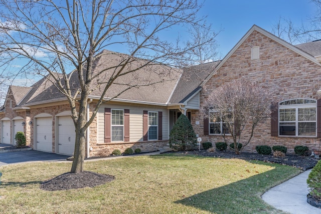 view of front facade with roof with shingles, a front lawn, a garage, stone siding, and aphalt driveway