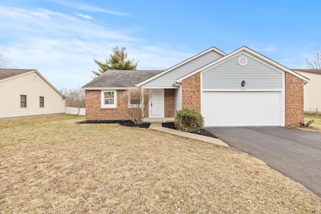 single story home with a front lawn, an attached garage, brick siding, and driveway