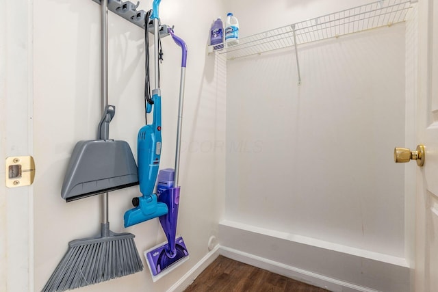 interior space featuring baseboards and wood finished floors