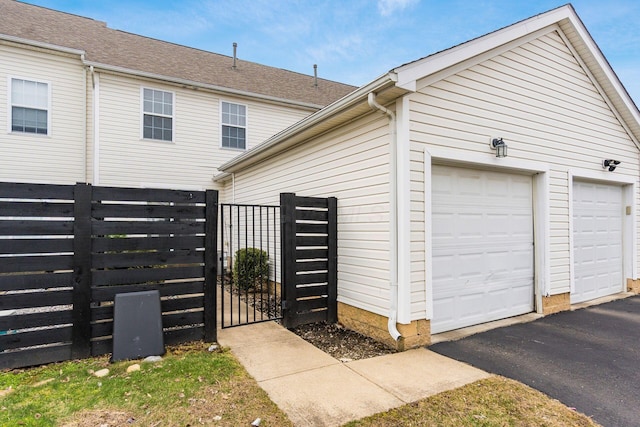 garage featuring a gate and fence