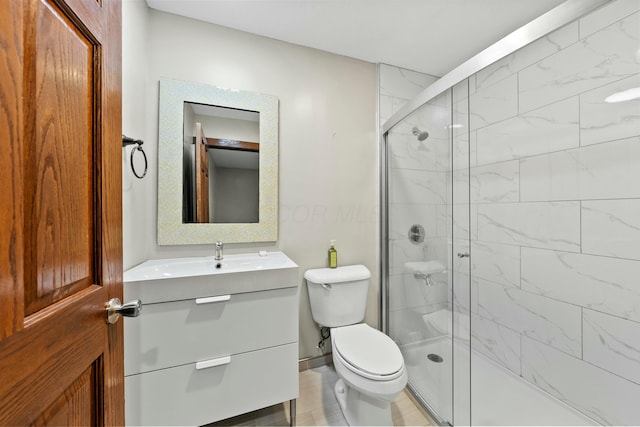 bathroom featuring a stall shower, vanity, and toilet