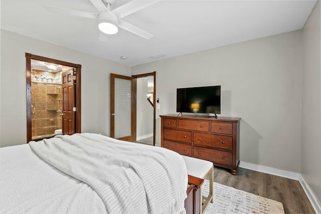 bedroom with ensuite bathroom, dark wood-style flooring, a ceiling fan, and baseboards